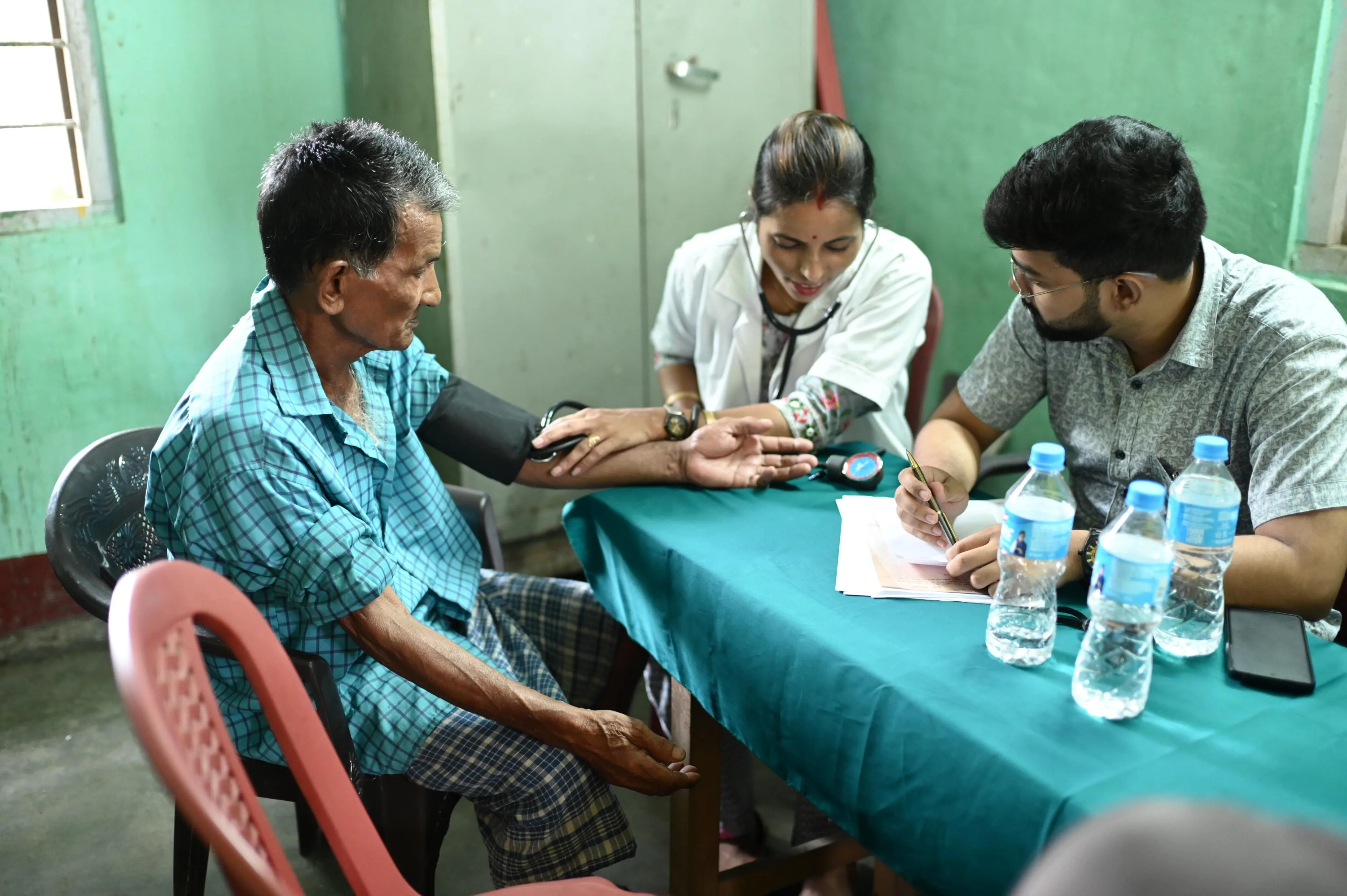 Health camp team distributing healthcare kits