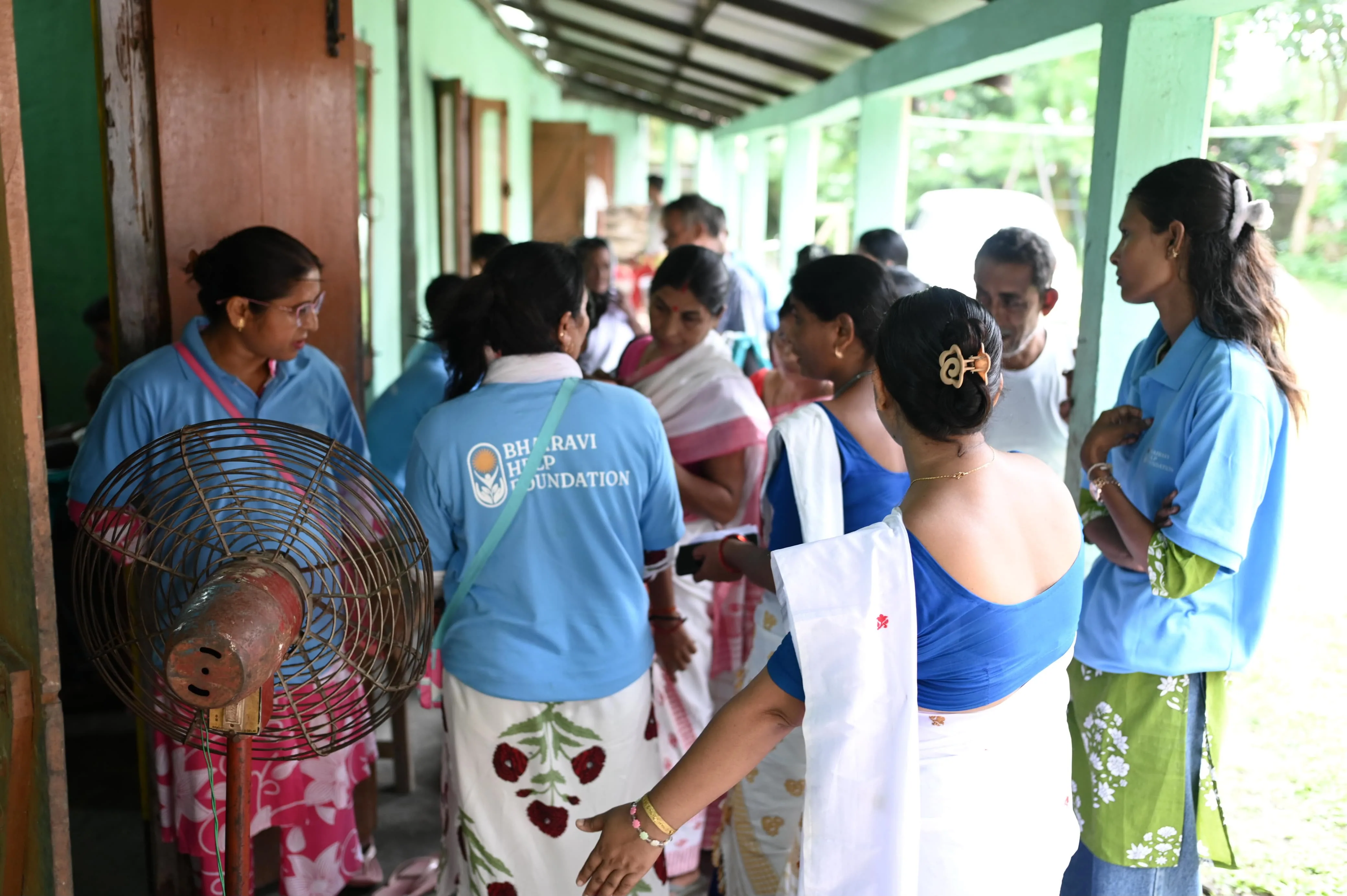 Volunteer helping senior patient at health camp