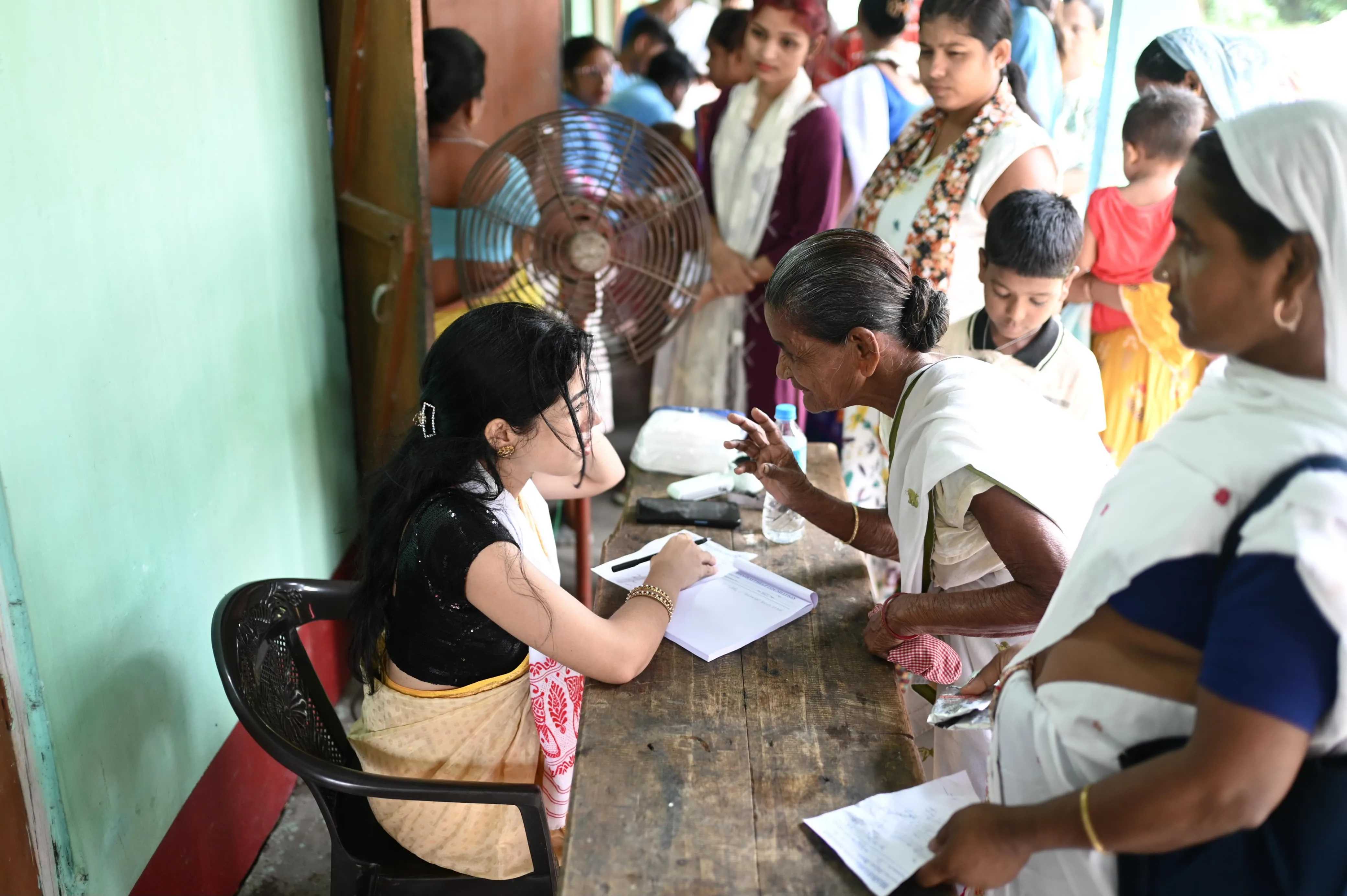 Child receiving wellness checkup from volunteer medical officer