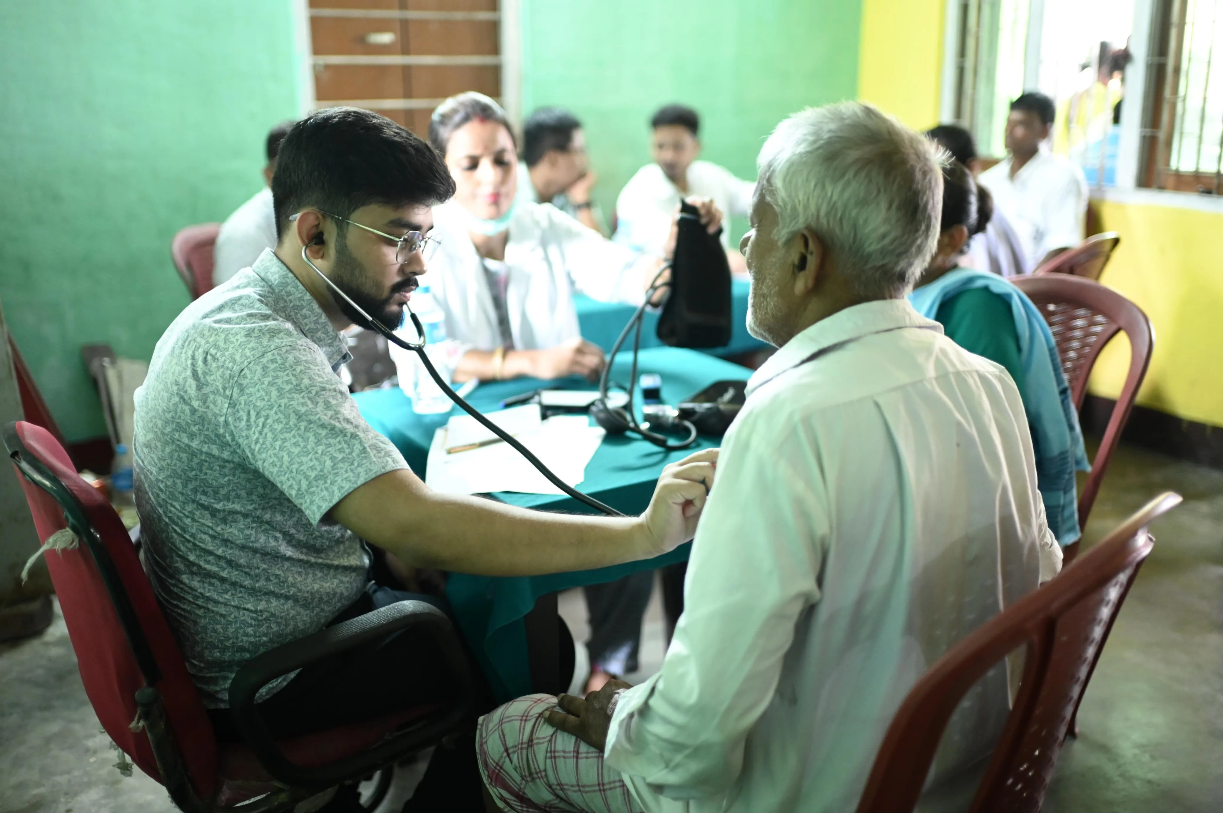 Health camp team interacting with community elders