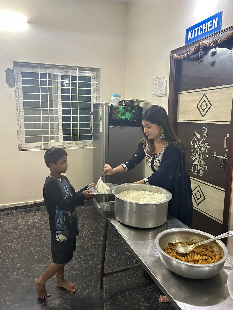 A volunteer helping a young boy during a relief or outreach drive