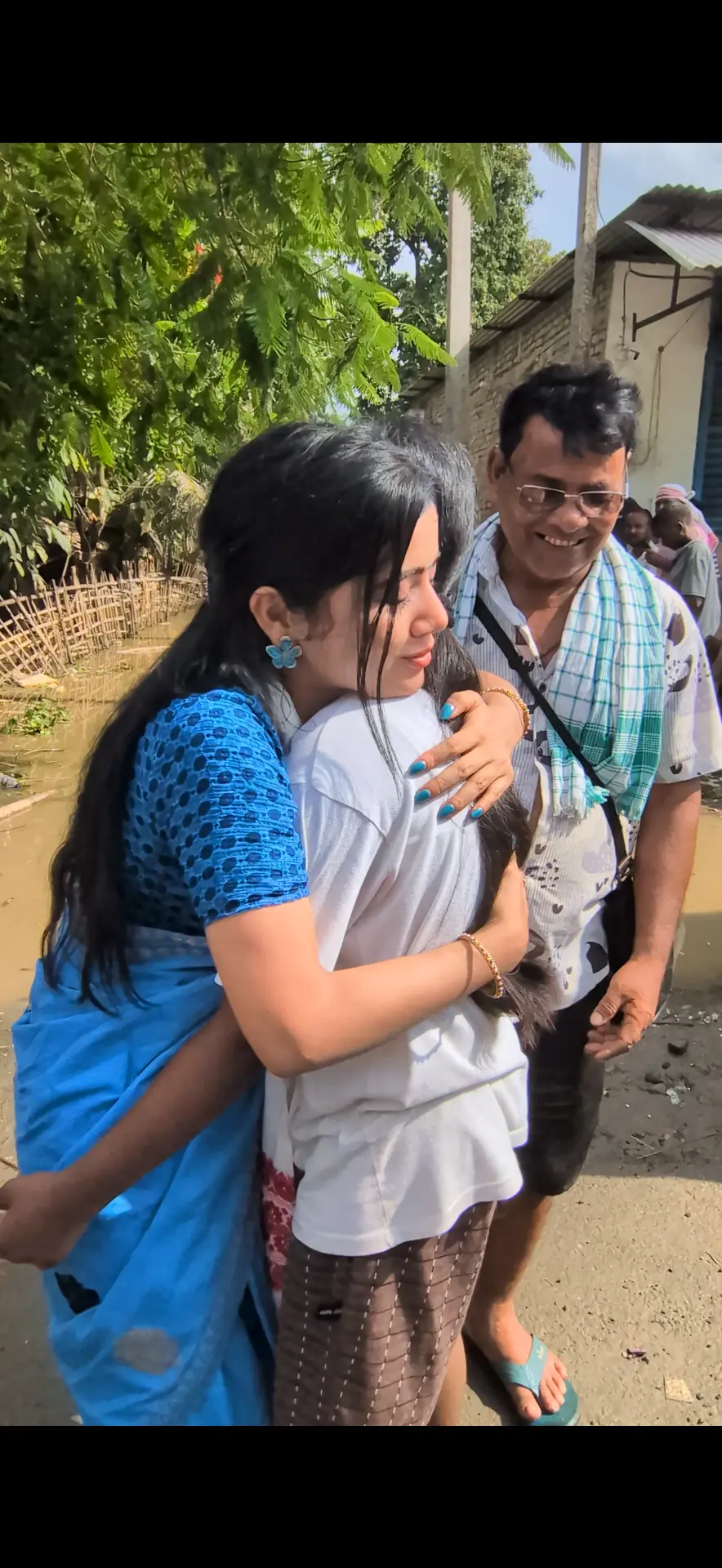 Bhairavi Aradhya Deka hugging a child rescued from a flooded village